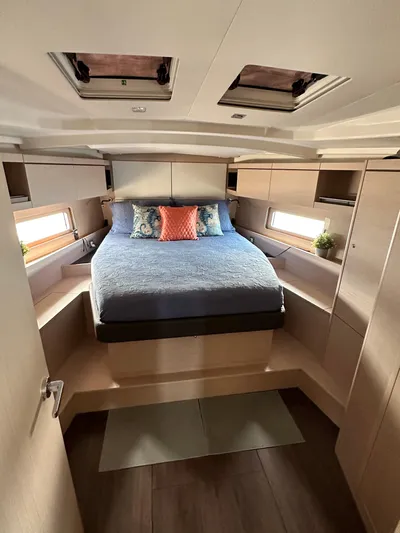 Chasing Summer Yacht Photos Pics Luxurious cabin interior of 2022 Beneteau Oceanis 46.1 yacht with cozy bed and modern design.