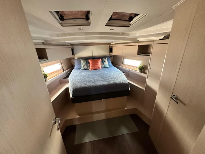 Chasing Summer Yacht Photos Pics Luxurious cabin interior of 2022 Beneteau Oceanis 46.1 yacht with cozy bed and modern design.