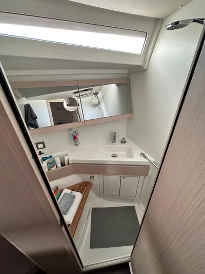 Chasing Summer Yacht Photos Pics Modern bathroom in 2022 Beneteau Oceanis 46.1 yacht, featuring sleek design and amenities.