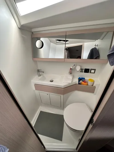 Chasing Summer Yacht Photos Pics Modern bathroom in 2022 Beneteau Oceanis 46.1 yacht, featuring sleek design and compact amenities.