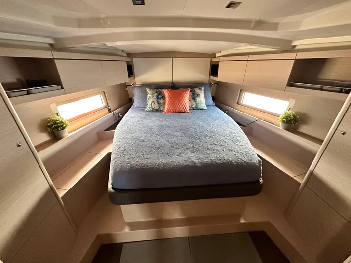 Chasing Summer Yacht Photos Pics Luxurious cabin interior of 2022 Beneteau Oceanis 46.1 yacht with cozy bed and modern design.