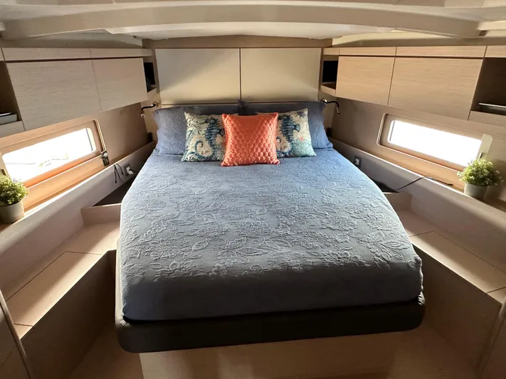 Chasing Summer Yacht Photos Pics Luxurious cabin interior of 2022 Beneteau Oceanis 46.1 yacht with elegant bedding and decor.