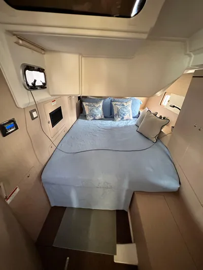 Chasing Summer Yacht Photos Pics Luxurious cabin interior of 2022 Beneteau Oceanis 46.1 yacht with cozy bedding.