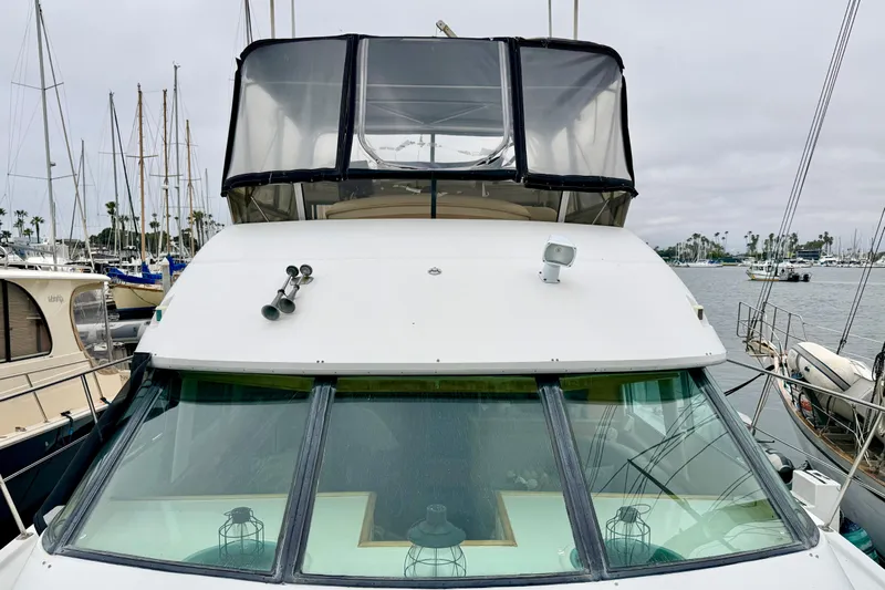 Lunasea Yacht Photos Pics 1996 Carver 500 Cockpit Motor Yacht docked at marina, overcast sky.