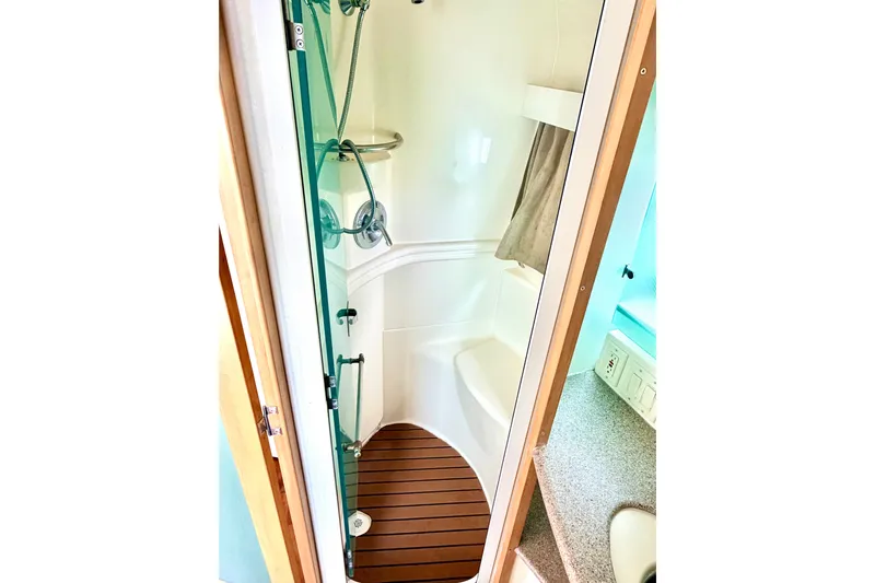 Lunasea Yacht Photos Pics Shower area in 1996 Carver 500 Cockpit Motor Yacht with wooden floor and modern fixtures.