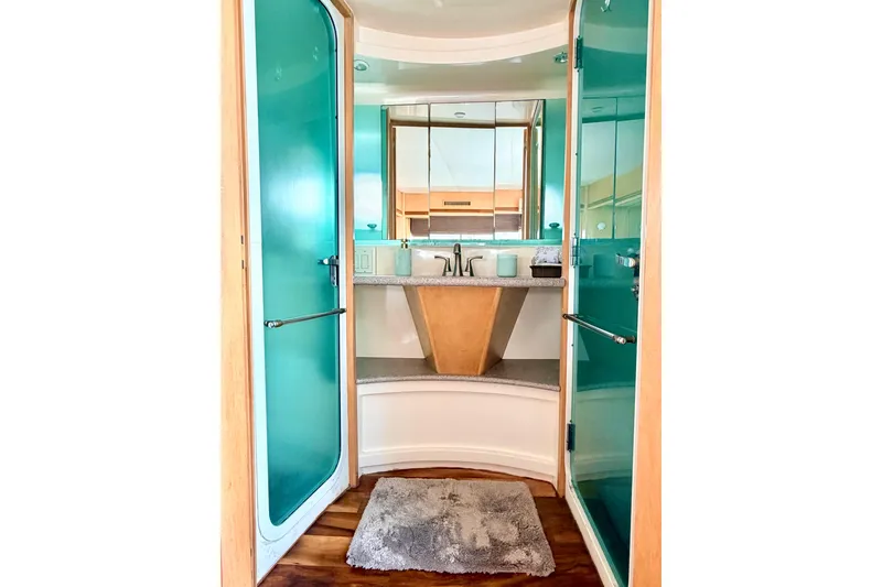 Lunasea Yacht Photos Pics Luxurious bathroom in 1996 Carver 500 Cockpit Motor Yacht with modern fixtures and teal accents.