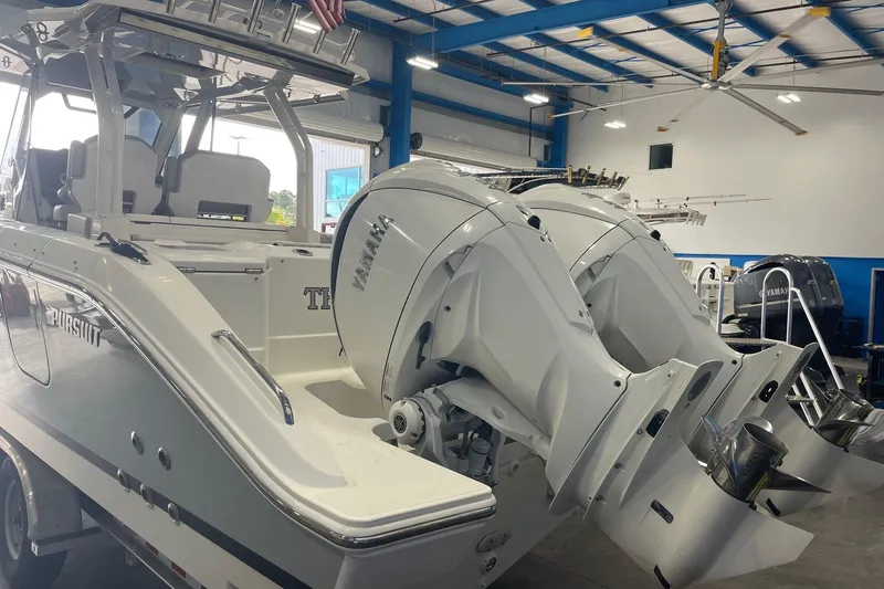 Three Point O.h. Yacht Photos Pics 2022 Pursuit S 328 Sport boat with dual Yamaha engines in a showroom.