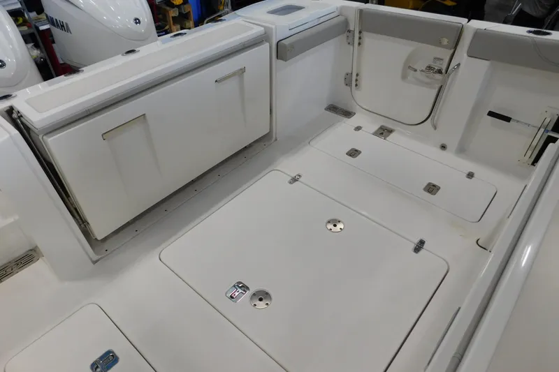 Three Point O.h. Yacht Photos Pics 2022 Pursuit S 328 Sport boat interior with storage compartments and Yamaha engines.