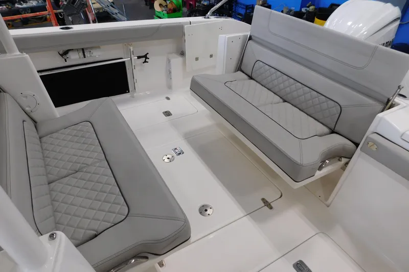 Three Point O.h. Yacht Photos Pics 2022 Pursuit S 328 Sport boat interior with gray quilted seating and sleek design.