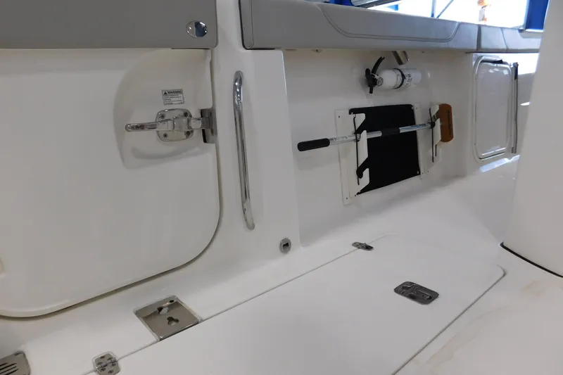 Three Point O.h. Yacht Photos Pics 2022 Pursuit S 328 Sport boat interior with storage compartments and safety equipment.