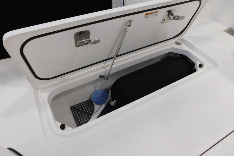 Three Point O.h. Yacht Photos Pics Open storage compartment on 2022 Pursuit S 328 Sport boat with cleaning brush inside.
