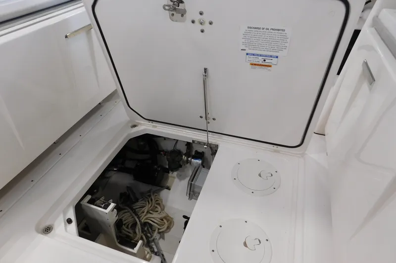 Three Point O.h. Yacht Photos Pics 2022 Pursuit S 328 Sport boat storage compartment with ropes and equipment.