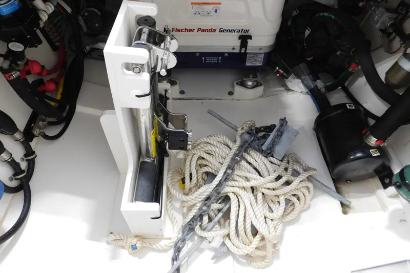 Three Point O.h. Yacht Photos Pics 2022 Pursuit S 328 Sport boat interior with generator, ropes, and equipment.