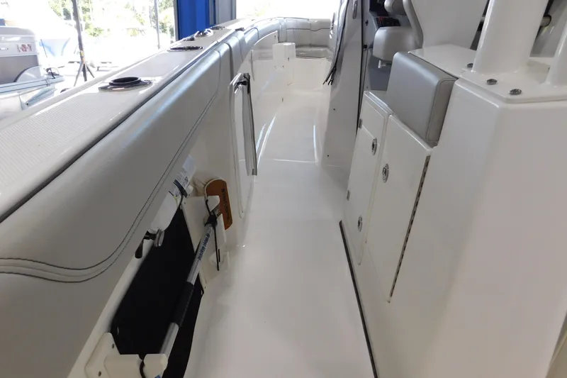 Three Point O.h. Yacht Photos Pics 2022 Pursuit S 328 Sport boat interior with sleek white design and storage compartments.