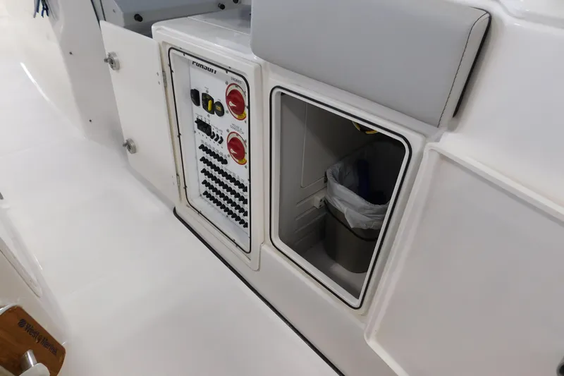 Three Point O.h. Yacht Photos Pics 2022 Pursuit S 328 Sport boat interior with control panel and storage compartment.