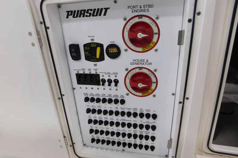 Three Point O.h. Yacht Photos Pics Electrical control panel of 2022 Pursuit S 328 Sport boat with switches and gauges.