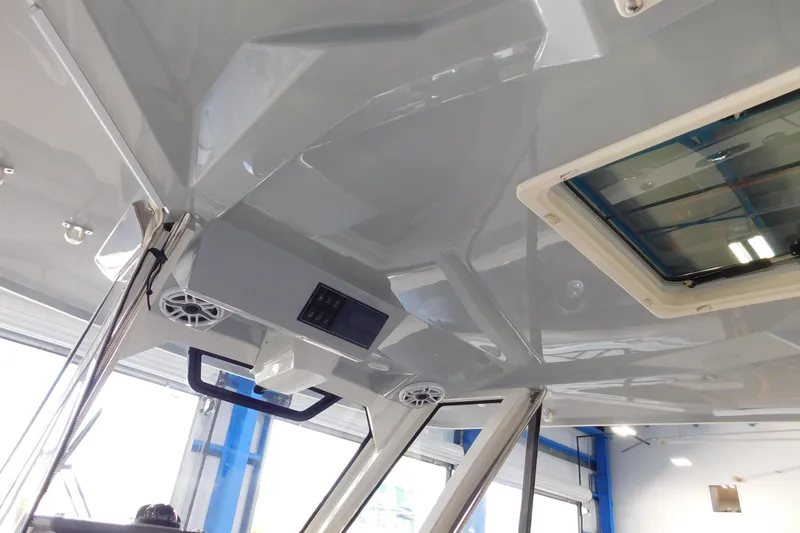 Three Point O.h. Yacht Photos Pics 2022 Pursuit S 328 Sport boat interior with speakers and hatch.