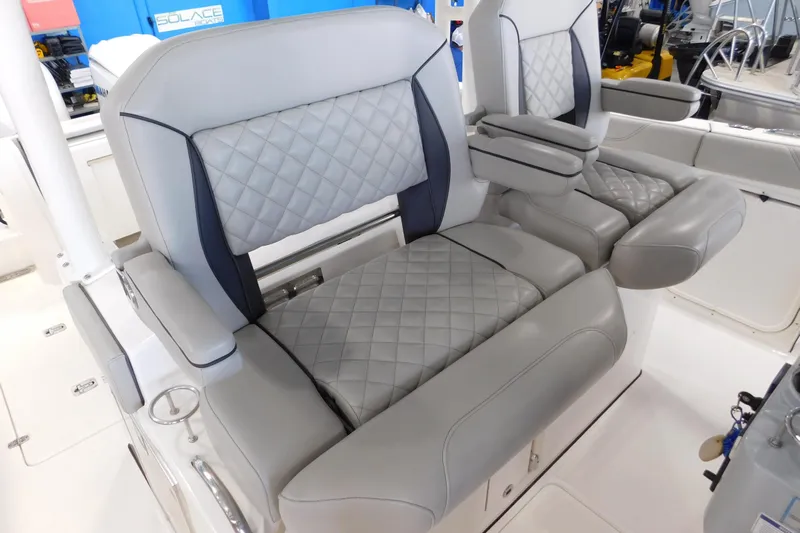 Three Point O.h. Yacht Photos Pics 2022 Pursuit S 328 Sport boat seats with quilted gray upholstery and armrests.