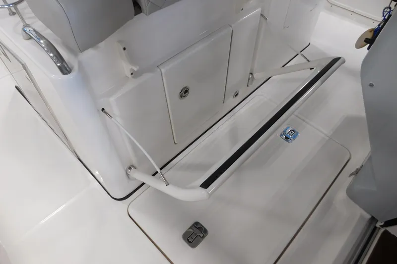 Three Point O.h. Yacht Photos Pics 2022 Pursuit S 328 Sport boat interior with seating and storage compartments.