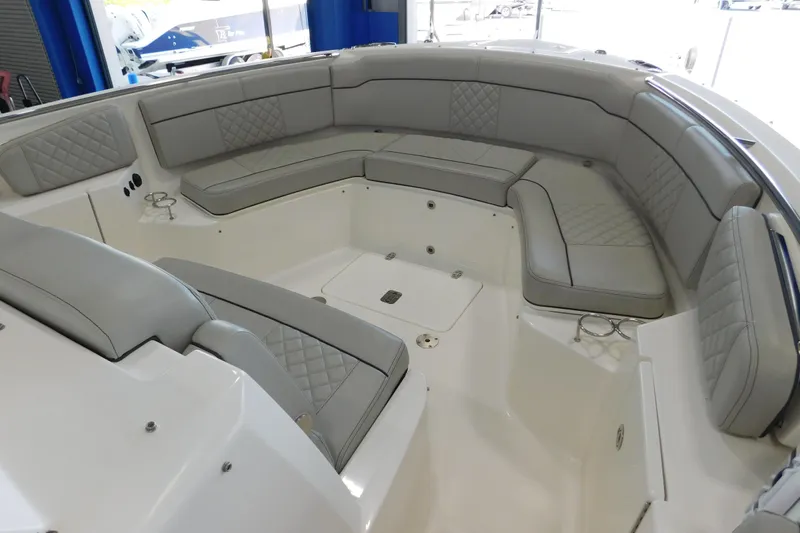 Three Point O.h. Yacht Photos Pics 2022 Pursuit S 328 Sport boat interior with luxurious gray seating and spacious layout.