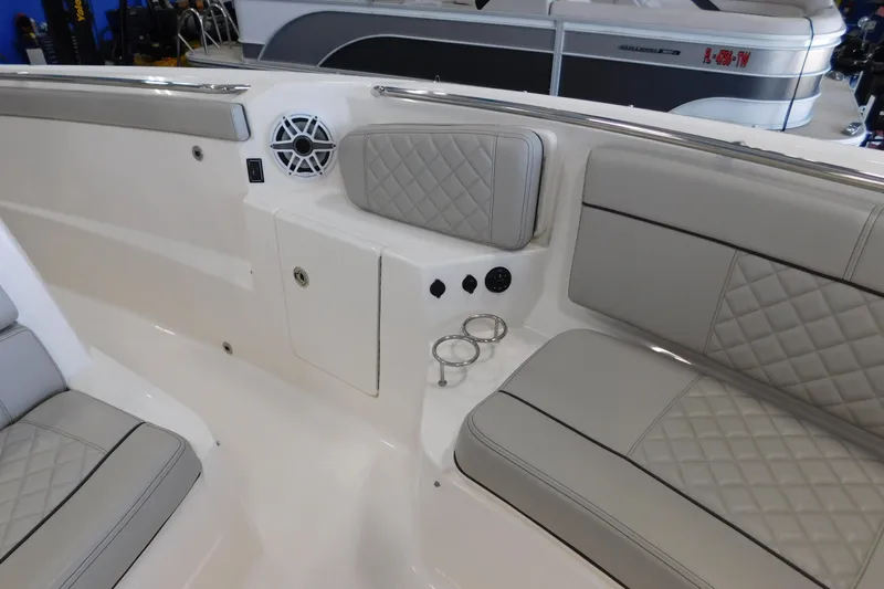 Three Point O.h. Yacht Photos Pics 2022 Pursuit S 328 Sport boat interior with cushioned seating and cup holders.