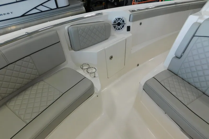 Three Point O.h. Yacht Photos Pics 2022 Pursuit S 328 Sport boat interior with quilted seating and cup holders.