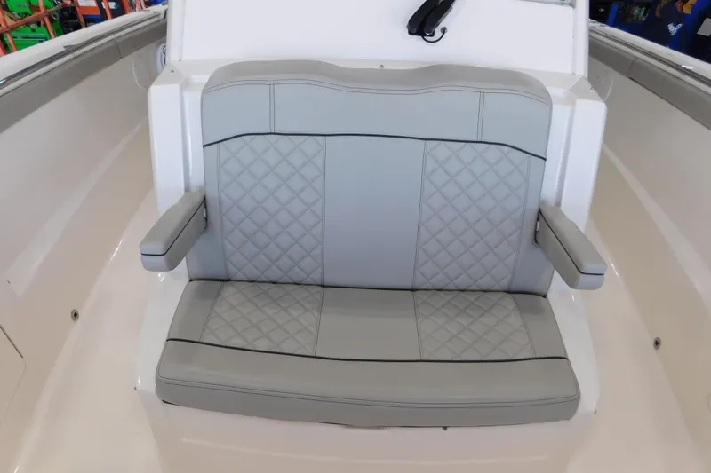 Three Point O.h. Yacht Photos Pics 2022 Pursuit S 328 Sport boat seat with gray quilted upholstery and armrests.
