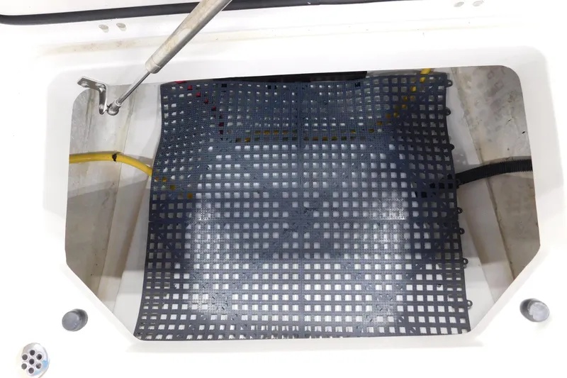 Three Point O.h. Yacht Photos Pics Open storage compartment with grid mat in 2022 Pursuit S 328 Sport boat.