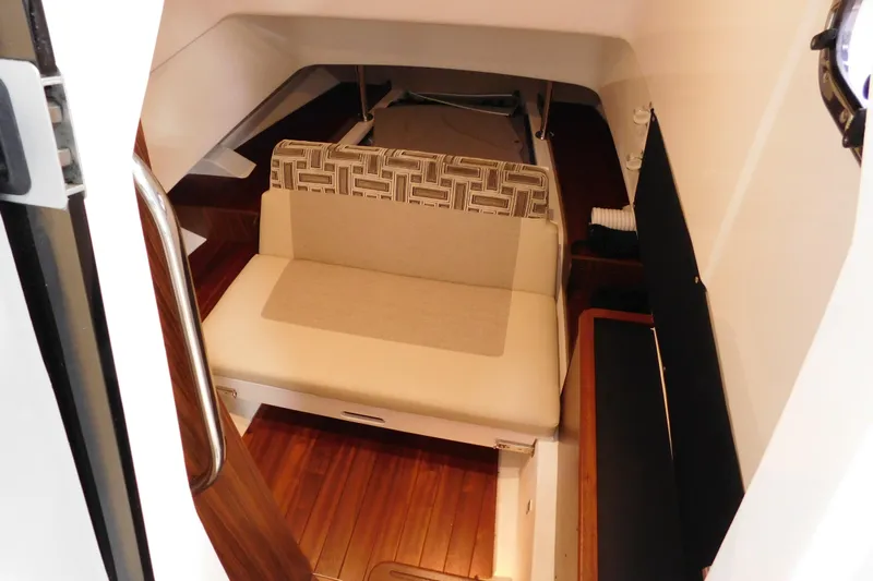 Three Point O.h. Yacht Photos Pics 2022 Pursuit S 328 Sport cabin interior with seating and wooden flooring.