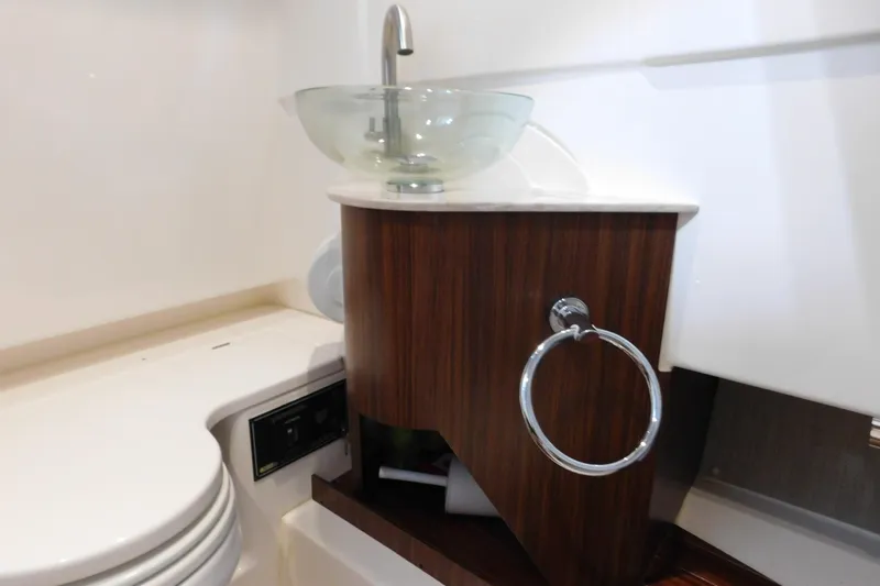 Three Point O.h. Yacht Photos Pics 2022 Pursuit S 328 Sport boat bathroom with modern sink and wooden cabinet.