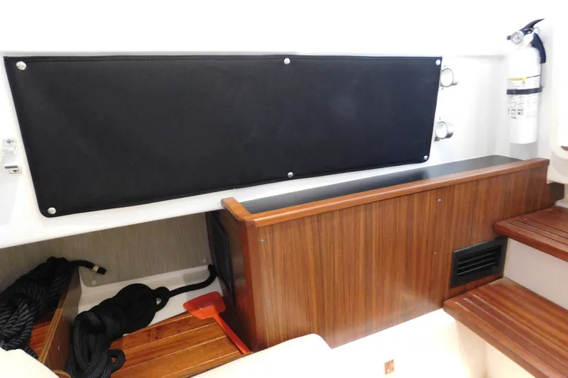 Three Point O.h. Yacht Photos Pics Interior of 2022 Pursuit S 328 Sport boat with wooden accents and safety equipment.