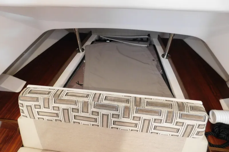Three Point O.h. Yacht Photos Pics 2022 Pursuit S 328 Sport interior with patterned seating and storage area.