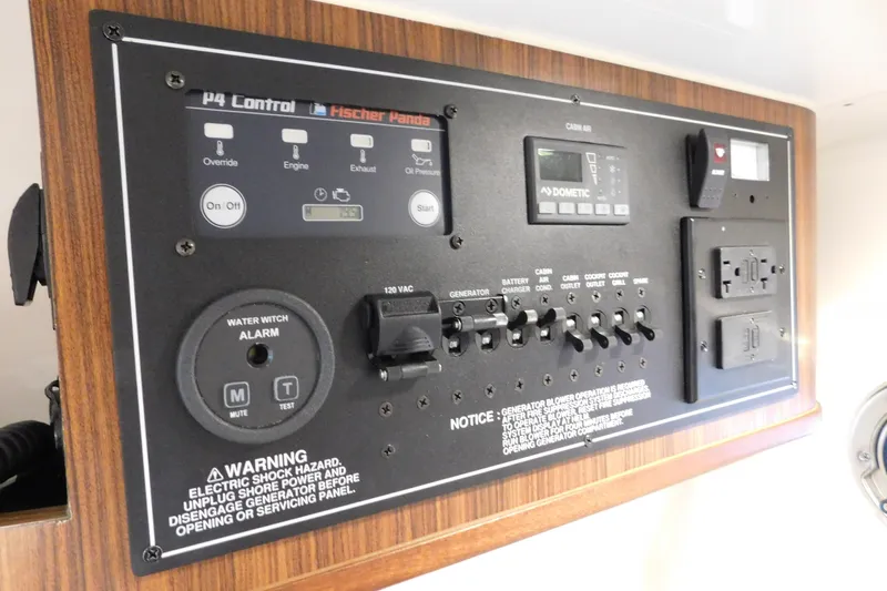 Three Point O.h. Yacht Photos Pics Control panel of a 2022 Pursuit S 328 Sport boat with various switches and warnings.