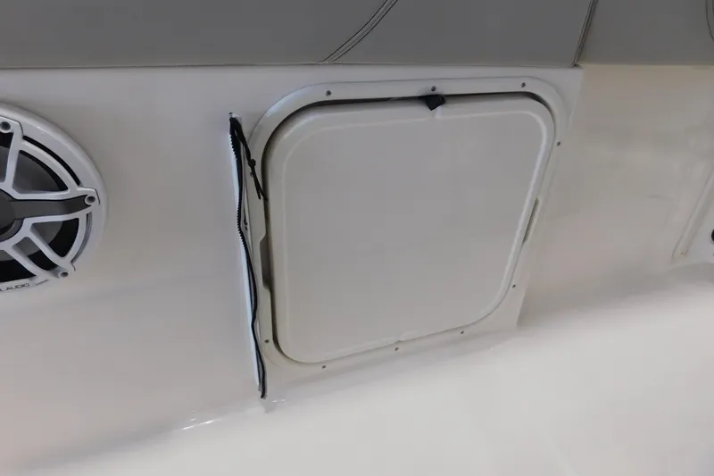 Three Point O.h. Yacht Photos Pics 2022 Pursuit S 328 Sport boat interior with speaker and storage compartment.