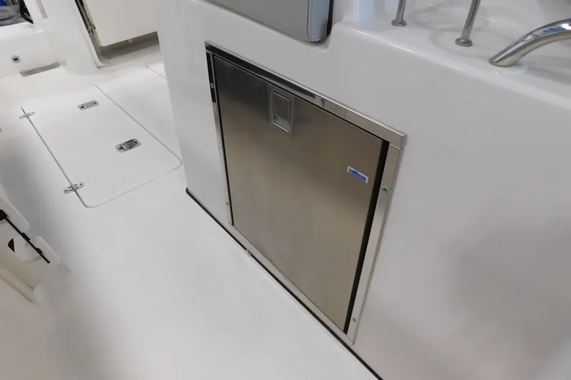 Three Point O.h. Yacht Photos Pics 2022 Pursuit S 328 Sport boat interior with stainless steel storage compartment.