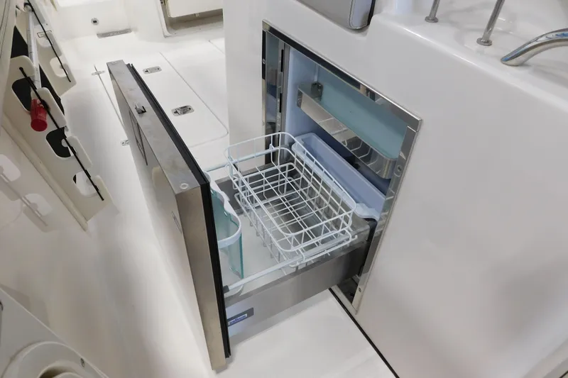 Three Point O.h. Yacht Photos Pics 2022 Pursuit S 328 Sport boat with open drawer refrigerator in cockpit area.