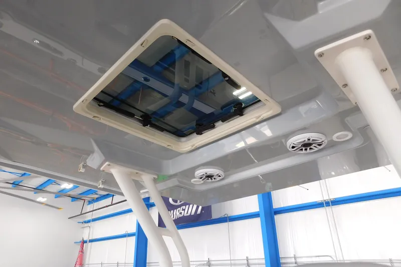 Three Point O.h. Yacht Photos Pics 2022 Pursuit S 328 Sport boat interior ceiling with hatch and speakers.