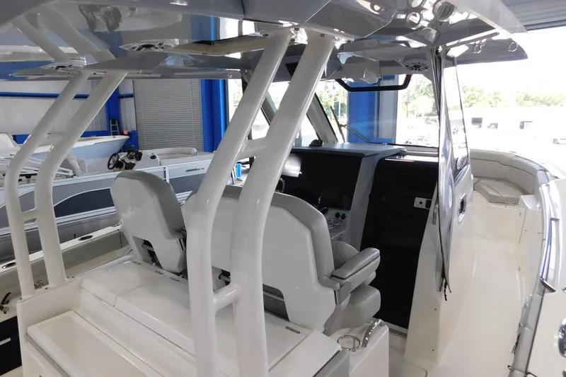 Three Point O.h. Yacht Photos Pics 2022 Pursuit S 328 Sport boat interior with modern helm and seating.