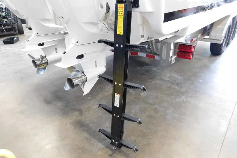 Three Point O.h. Yacht Photos Pics Rear view of 2022 Pursuit S 328 Sport boat with dual outboard motors and ladder.