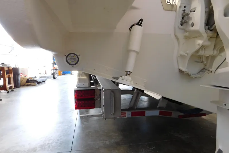 Three Point O.h. Yacht Photos Pics 2022 Pursuit S 328 Sport boat on trailer in garage setting.