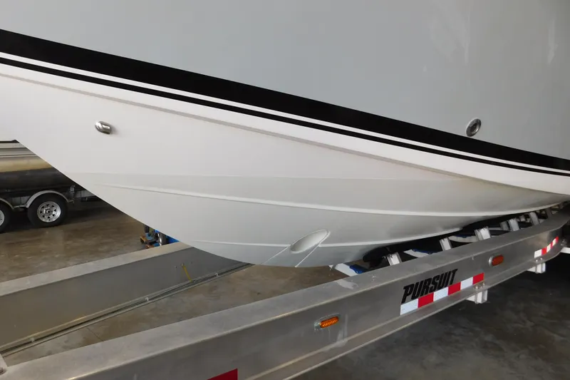 Three Point O.h. Yacht Photos Pics 2022 Pursuit S 328 Sport boat on trailer, close-up view of hull design.