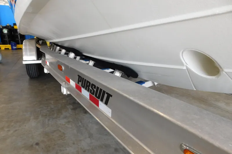 Three Point O.h. Yacht Photos Pics 2022 Pursuit S 328 Sport boat on trailer in garage setting.