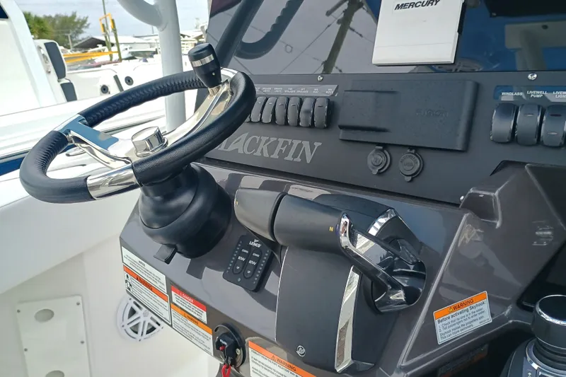  Yacht Photos Pics 2025 Blackfin 272 CC boat dashboard with steering wheel and controls.