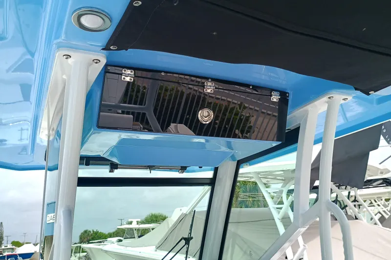  Yacht Photos Pics 2025 Blackfin 272 CC boat console with blue finish and storage compartment.