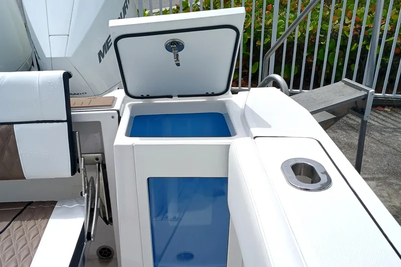  Yacht Photos Pics 2025 Blackfin 272 CC boat with open storage compartment and seating area.