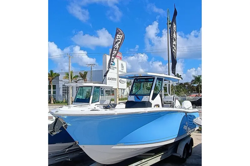  Yacht Photos Pics 2025 Blackfin 272 CC boat in blue, displayed outdoors under a clear sky.
