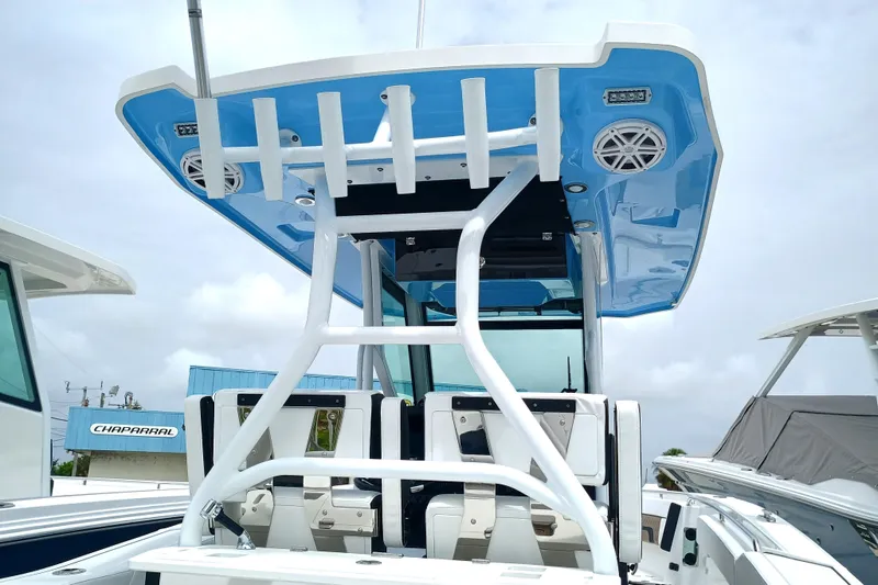  Yacht Photos Pics 2025 Blackfin 272 CC boat with blue T-top and rod holders, docked outdoors.