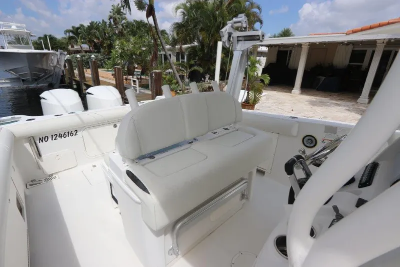  Yacht Photos Pics 2013 Sailfish 320 CC boat interior with seating and controls.