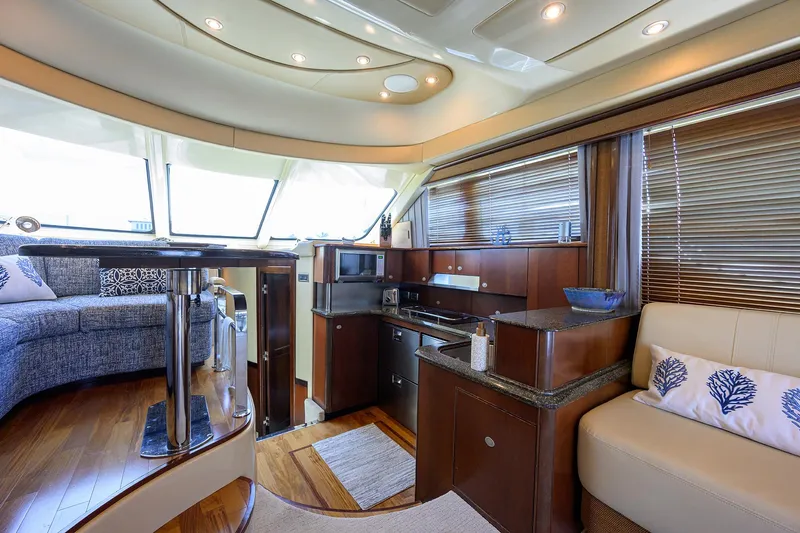 Yes Dear Yacht Photos Pics Luxurious interior of 2005 Sea Ray 52 Sedan Bridge yacht with modern kitchen and seating area.