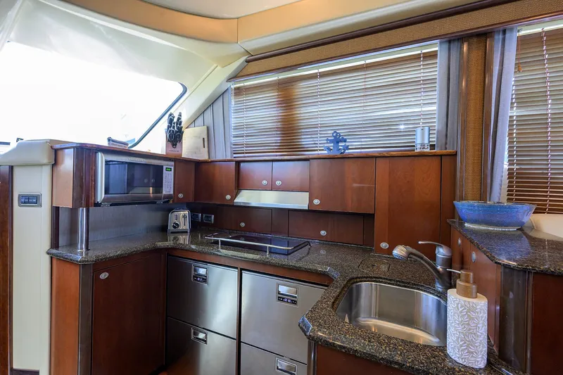 Yes Dear Yacht Photos Pics Luxurious kitchen interior of 2005 Sea Ray 52 Sedan Bridge yacht with modern appliances.